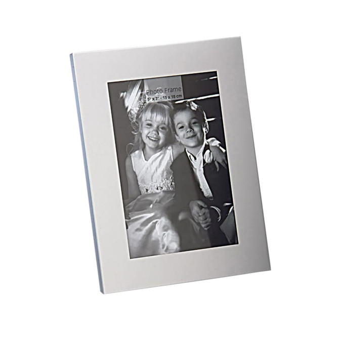 A classic aluminium photo frame in silver, featuring a portrait orientation and an image of two children.