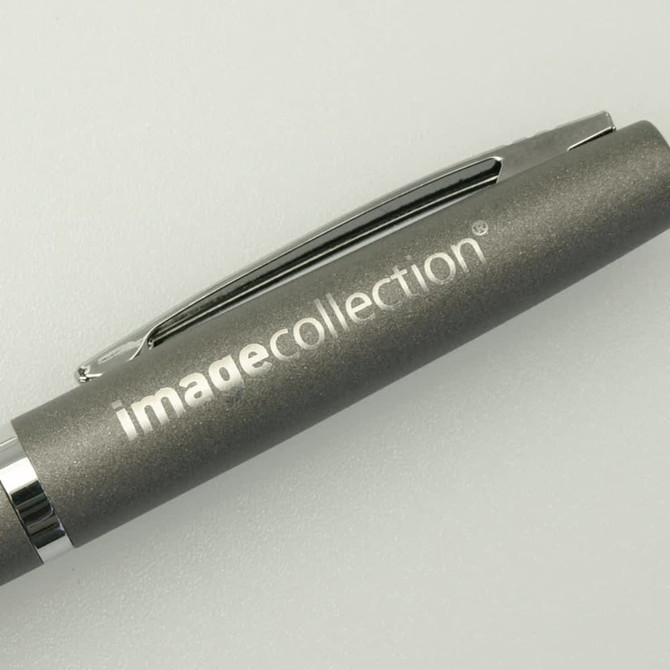 A grey pen with a silver clip and branding on the barrel.