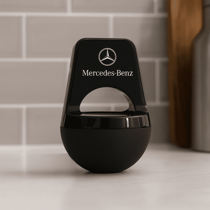 A black wireless speaker with a rounded base and a logo on the front, featuring a sleek and modern design.