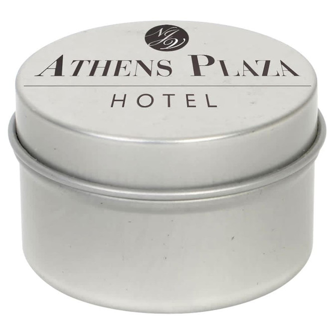 A silver tin candle with a lid, featuring a logo and the text "Athens Plaza Hotel".