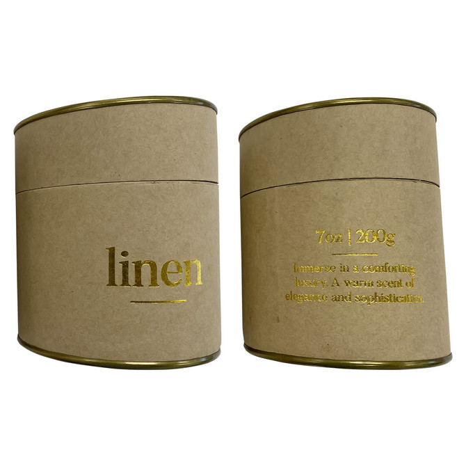 A large candle in a round, kraft paper container with gold accents and text, featuring a linen scent.