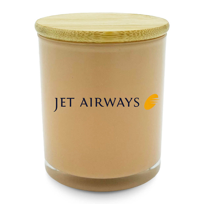 A medium beige candle with a bamboo lid and a logo on the front.