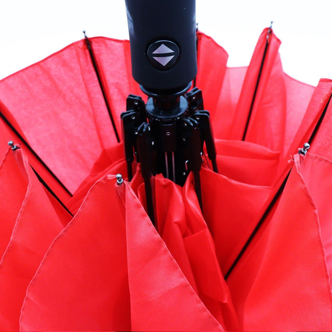 A red umbrella with a black handle and a logo, featuring multiple panels.