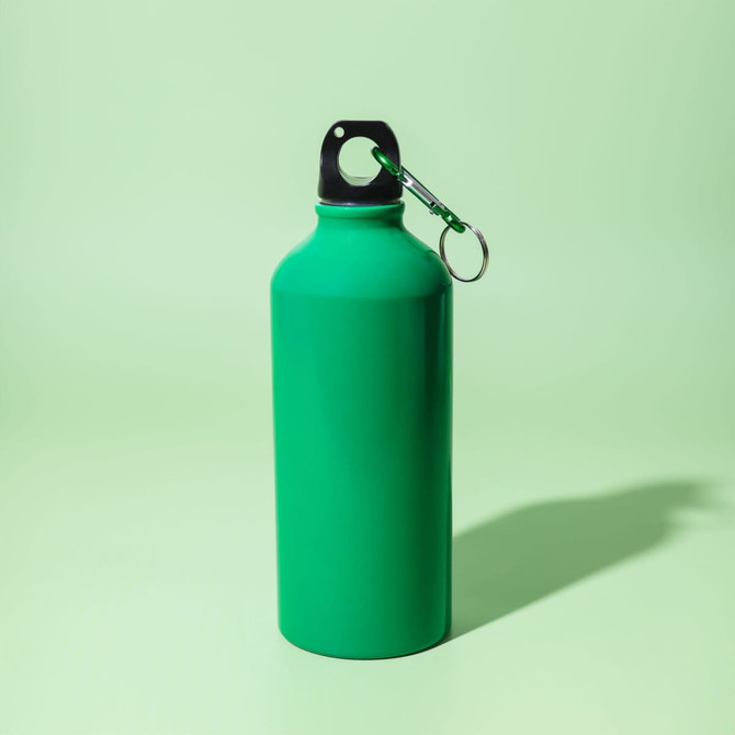 A drink bottle in vibrant green with a black cap and keyring attachment, set against a light green background.