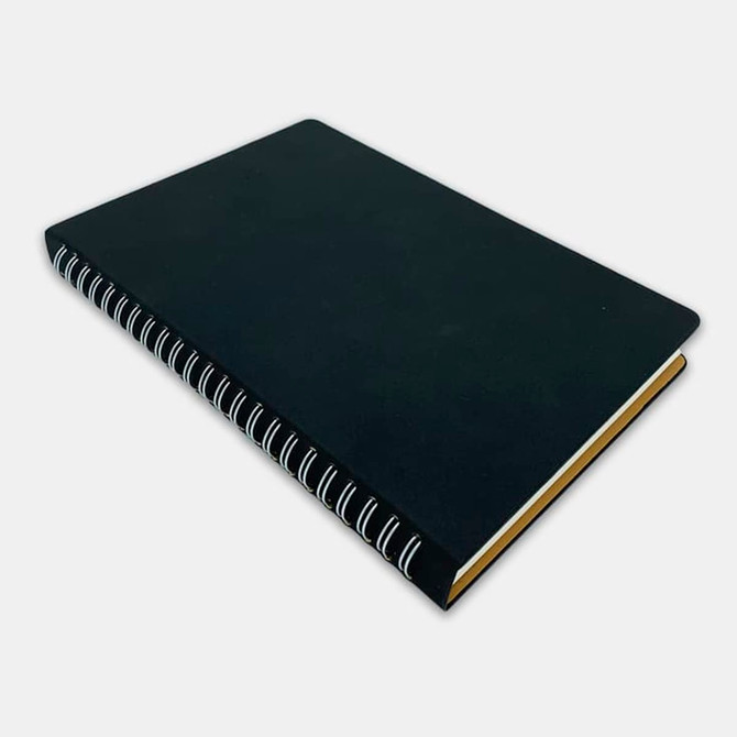 A black spiral notebook with a textured cover and contrasting white spirals along the spine.