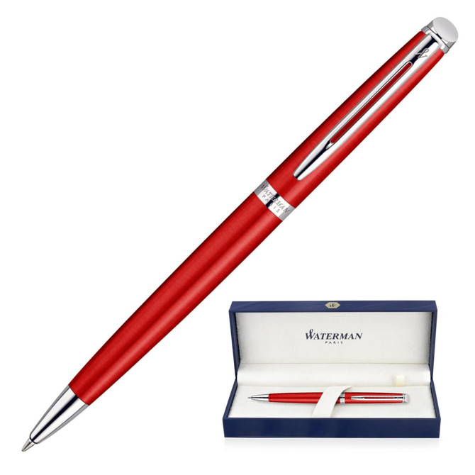 A ballpoint pen in comet red with chrome accents, displayed in a blue box with branding.