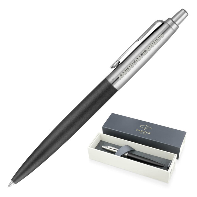 A matte black ballpoint pen with a silver clip and branding, displayed in an elegant box.