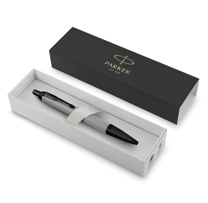 A matte grey ballpoint pen in a black and white presentation box, featuring a logo.