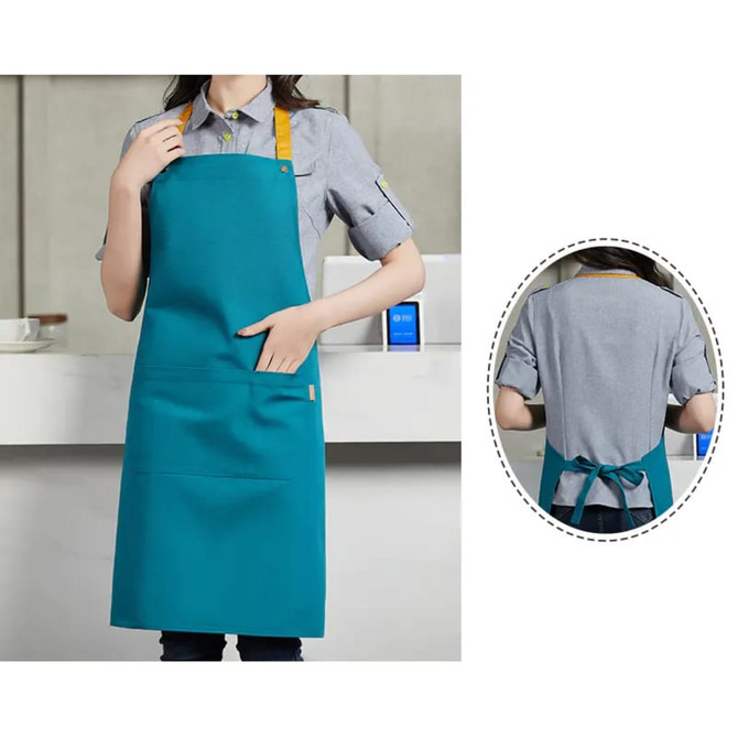 A poly-cotton canvas apron in teal with a colour neck strap, featuring a front pocket and a logo.