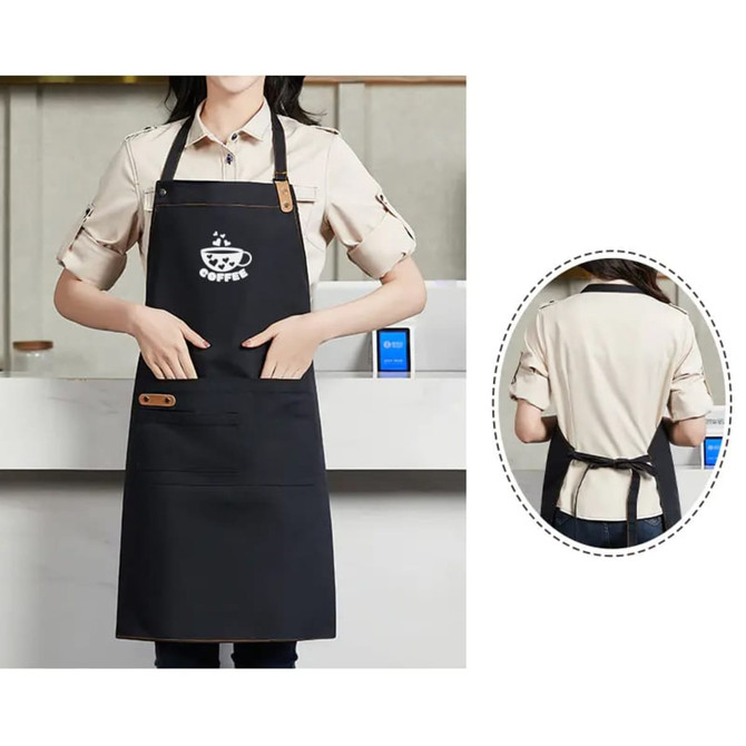 A black poly-cotton canvas full bib apron with a neck strap and a logo, featuring pockets for convenience.