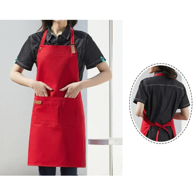 A red poly-cotton canvas full bib apron with a neck strap and a front pocket, featuring a logo.