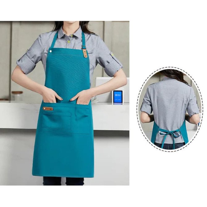 A teal poly-cotton canvas full bib apron with a neck strap, featuring a pocket and a back tie.