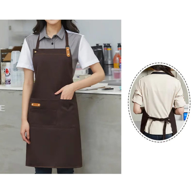 A brown poly-cotton canvas bib apron with a neck strap and front pocket, featuring a logo.