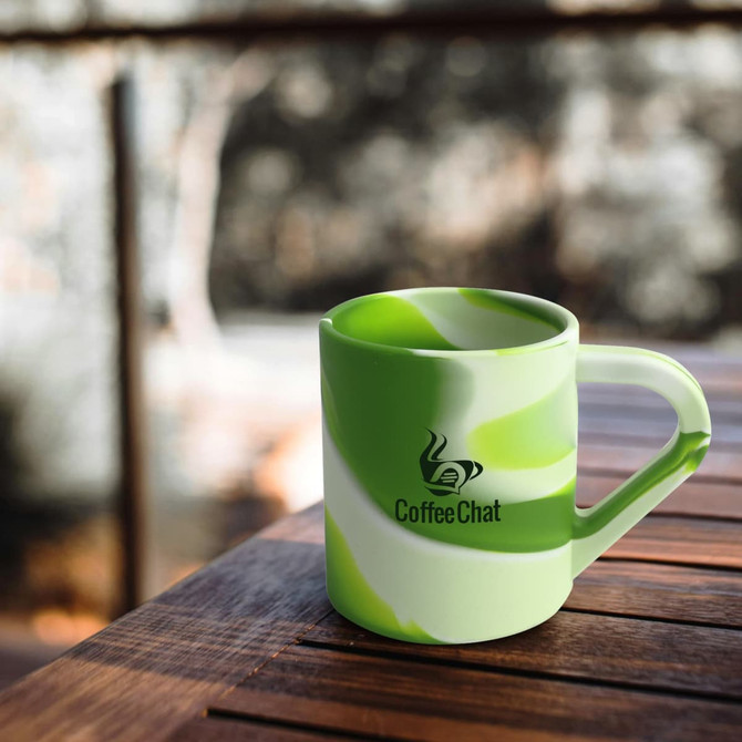 A drink mug in green and white marble design with a handle and a logo.
