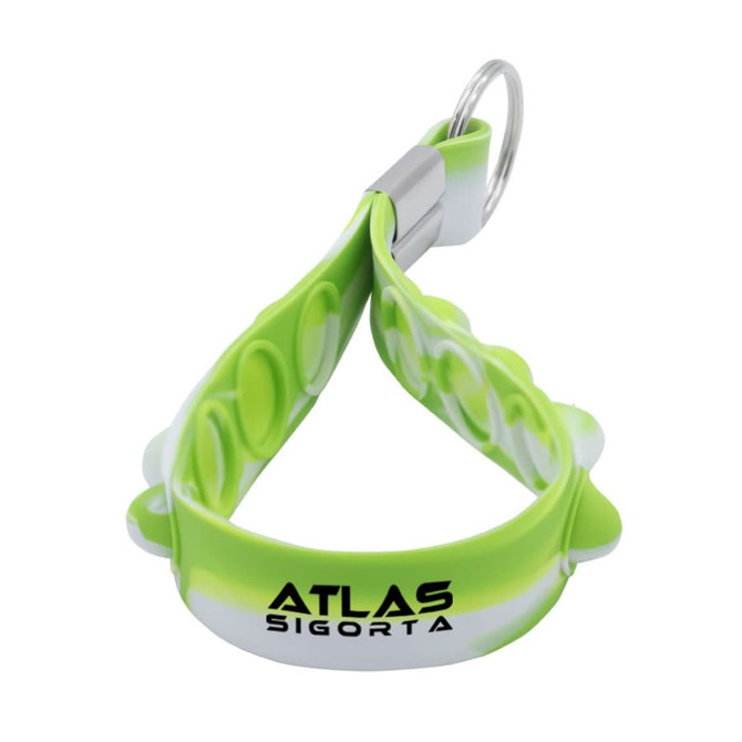 A bright green and white silicone keychain with a textured design and a metal keyring attachment. 