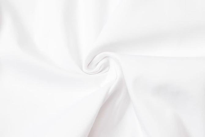 A smooth, white fabric in a swirling pattern, suitable for uniforms or chefwear.