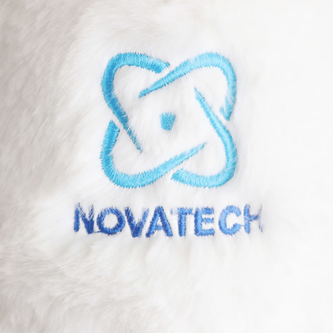 A plush toy with soft white fur featuring an embroidered blue and dark blue logo.