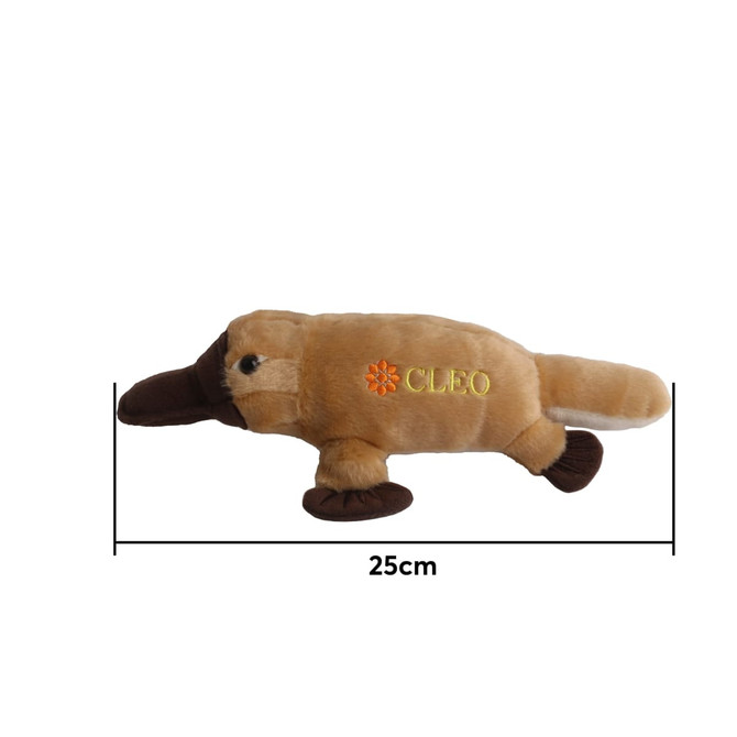 A brown and beige platypus plush toy, measuring 25 cm, with a logo on its side.