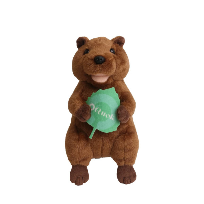 A brown quokka plush toy holding a green leaf, featuring a happy expression and soft texture.