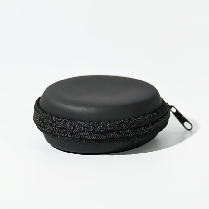 A round black zippered case with a smooth finish, suitable for storing small items.