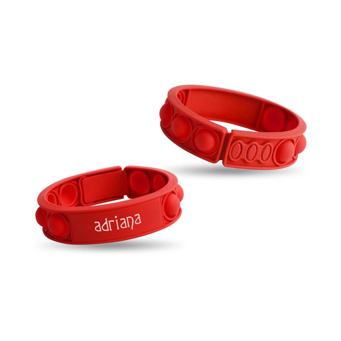 Two red silicone wristbands with textured bubble sections, one featuring a logo and the other plain.