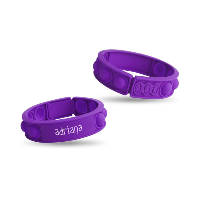 Two purple silicone wristbands featuring raised bubbles and a logo, designed as a fidget novelty item.