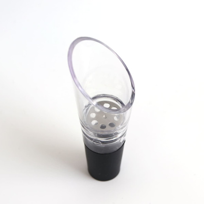 A wine aerator in clear plastic with a black base, featuring a perforated insert for aeration.