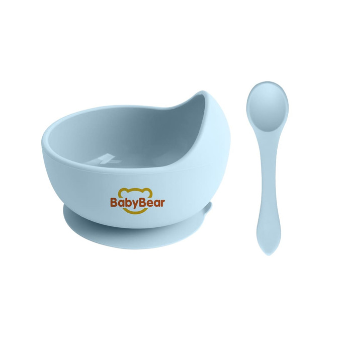 A light blue silicone kids suction bowl with a matching spoon, featuring a logo on its side.