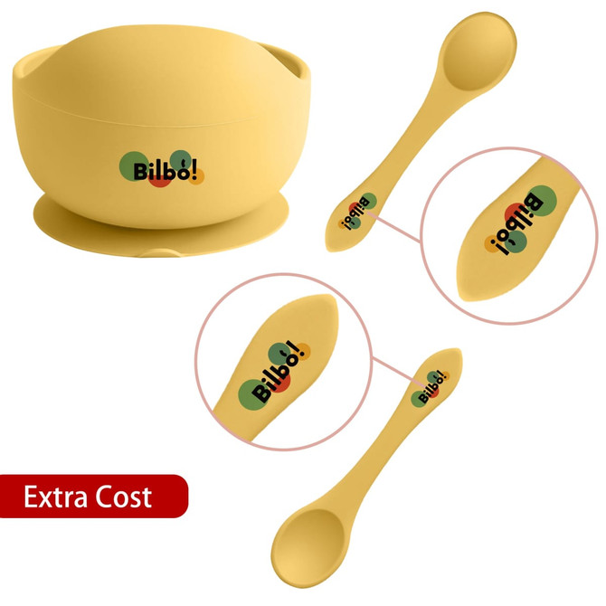 A yellow silicone kids suction bowl with matching yellow spoon, featuring a logo. Suitable for home dining use.