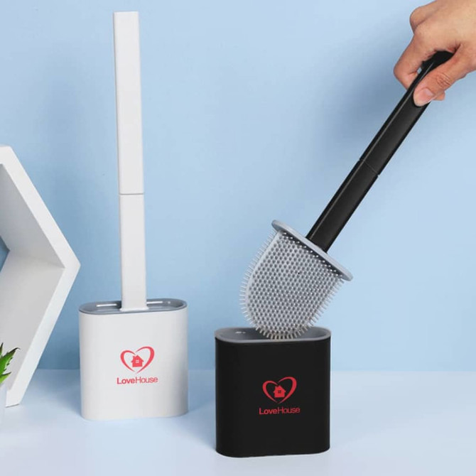 A silicone toilet brush with a black handle and white holder, featuring a logo, placed beside a modern hexagonal design.