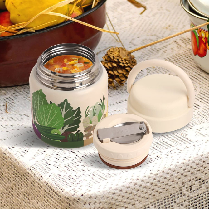 A stainless steel vacuum insulated food jar in cream, with a lid and an attached spoon. Features colourful vegetable designs.