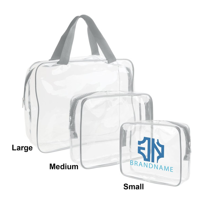 Three clear toiletry bags in varying sizes: large, medium, and small, all with grey trim and handles. One bag features a logo.