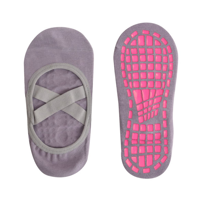 A pair of grey yoga socks featuring a cross strap design and a pink, slip-resistant sole.