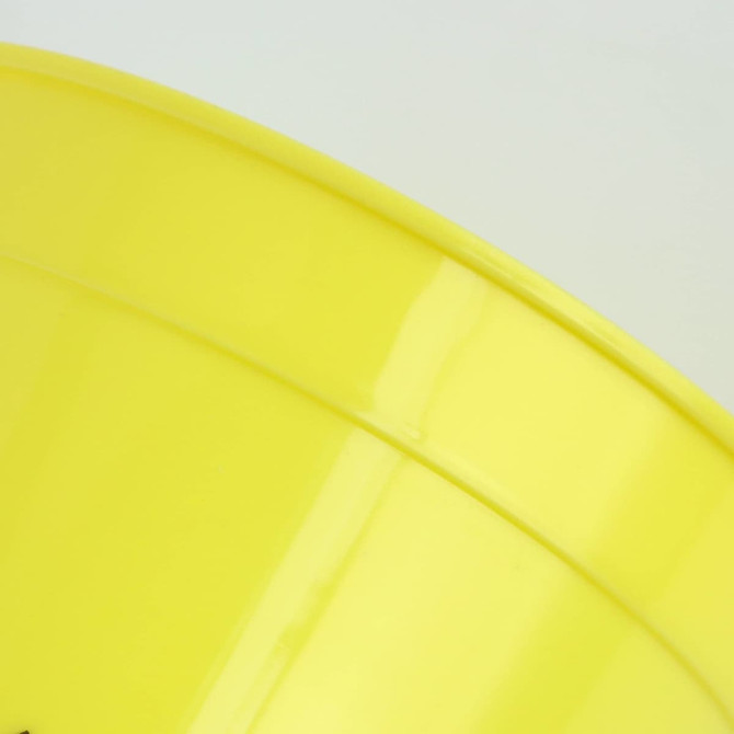 A yellow plastic stadium cup with a glossy finish and a logo on the surface.