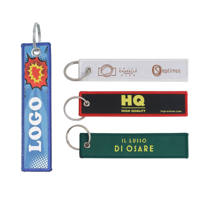 Woven key tags in various colours, featuring different designs and a metal keyring attachment.