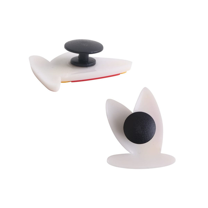 Two white clog shoe charms with a black button, featuring unique shapes and designs.