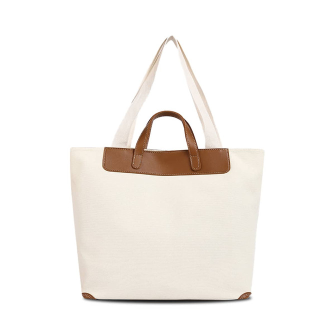 A canvas bag in natural white with a brown leather handle, featuring a structured design and two sturdy straps.
