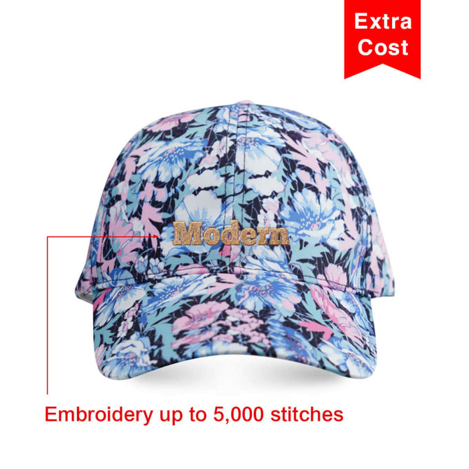 A floral-patterned 6 panel cap featuring a logo, primarily in shades of blue, pink, and black.