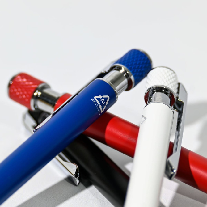 Assorted ball pens in blue, red, white, and black, featuring metallic accents and a logo on one pen.