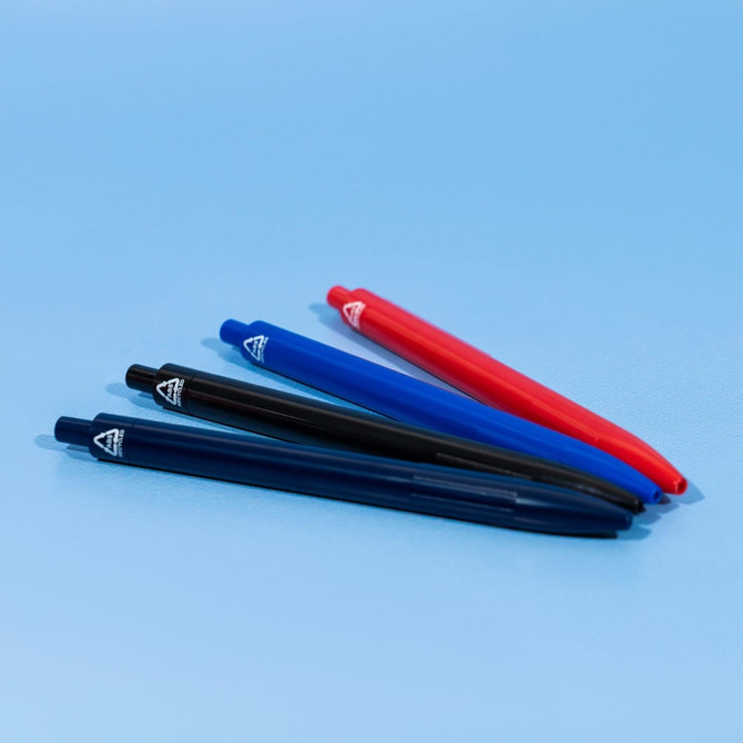 Four pens arranged neatly, featuring black, blue, and red colours, on a light blue background. Each pen has a logo.