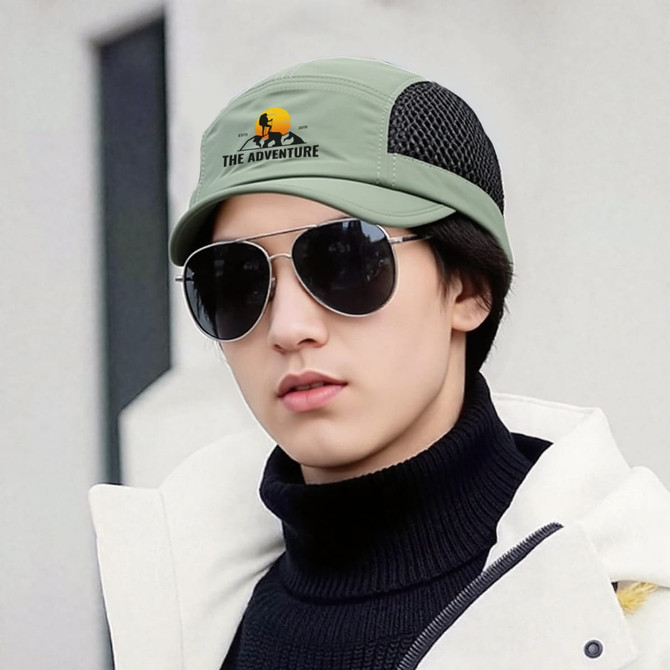 A short brimmed mesh running cap in olive green, featuring a logo and worn with sunglasses by a person.