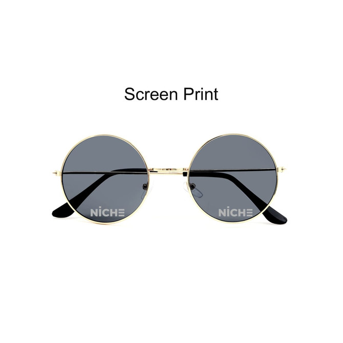 Retro round sunglasses with gold frames and dark lenses. Features a logo on the lens.