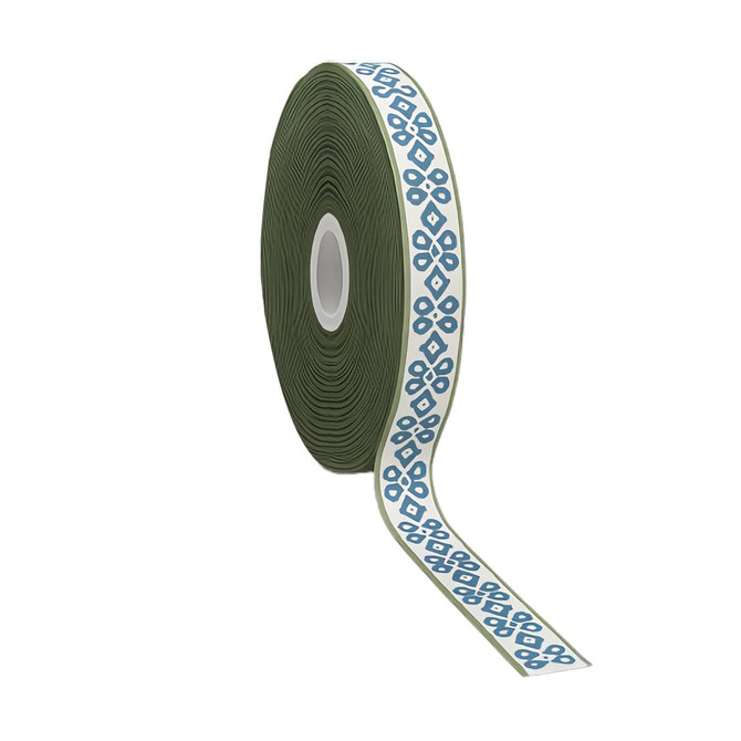 A roll of satin polyester ribbon featuring a geometric pattern in blue on a cream background, with a green core.