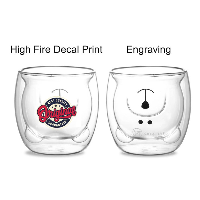 A double wall glass with a bear design, featuring a red and blue decal on one side and a simple engraving on the other.