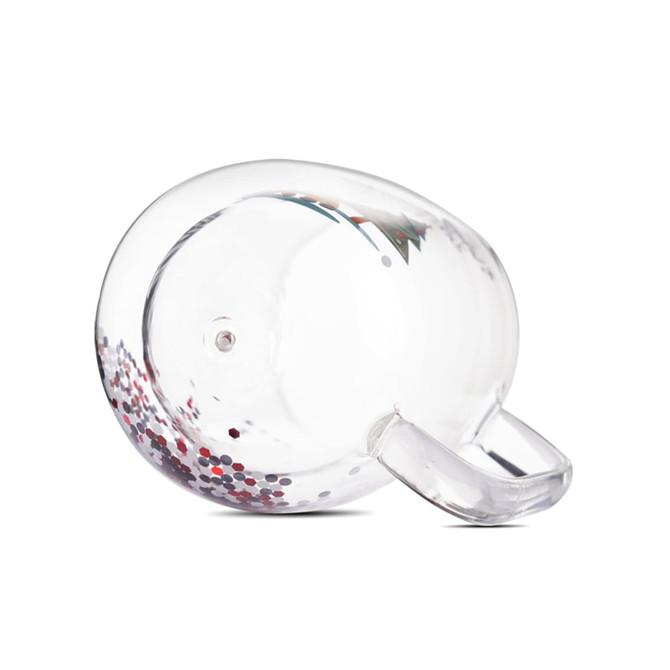 A clear glass mug featuring a double wall design with red and silver glitter inside, and a handle.
