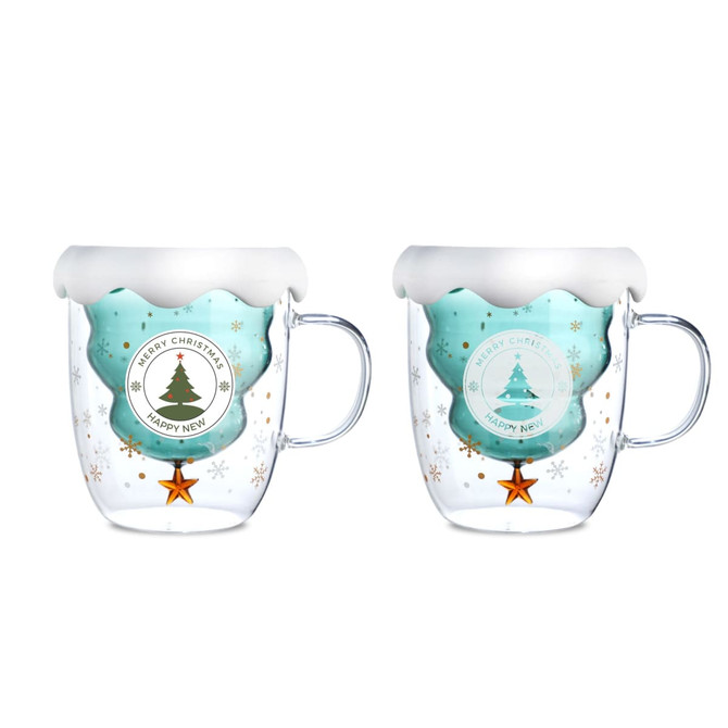 A double wall mug featuring a festive Christmas tree design, with clear and teal colours, and a snowy white rim.