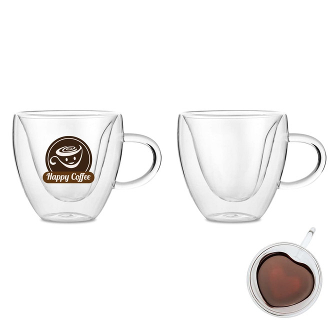 A heart-shaped double wall mug in clear glass with a handle and a logo. Features a light brown design inside.