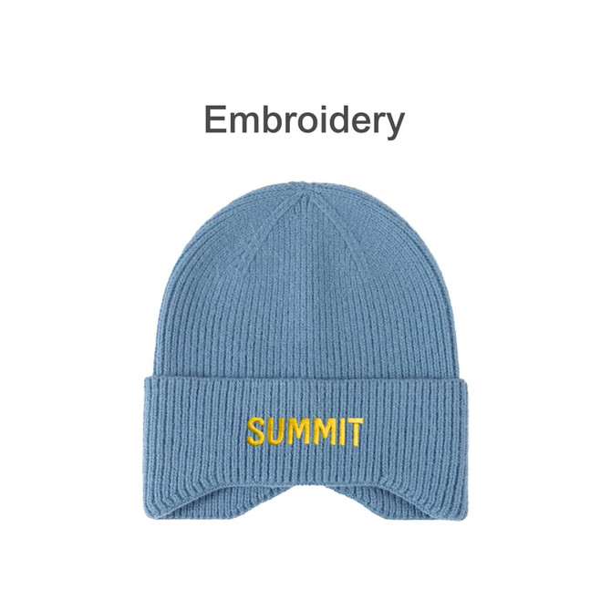 A blue earflap beanie with a ribbed texture and yellow embroidery. Features a logo on the front.