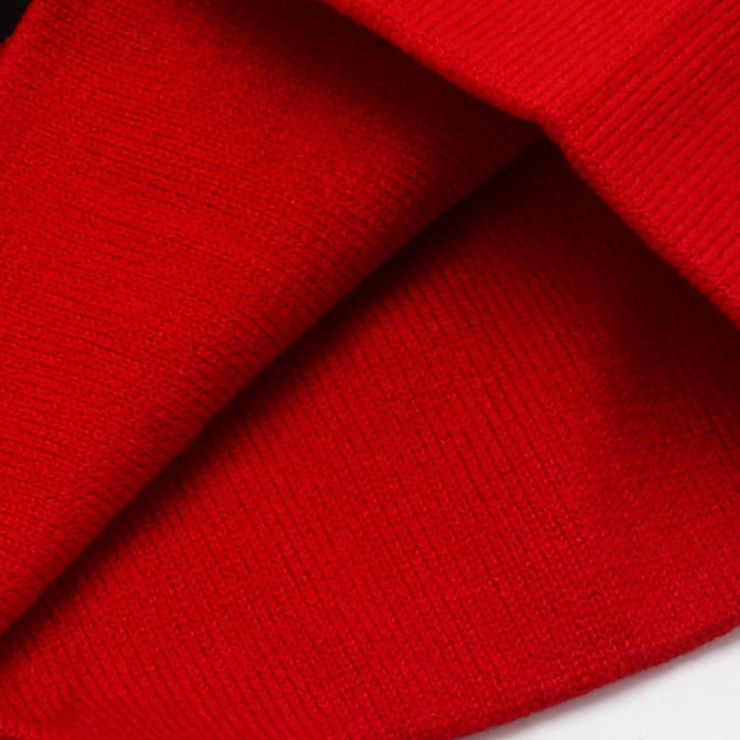 A red Jacquard beanie featuring a textured knit pattern and a folded brim.