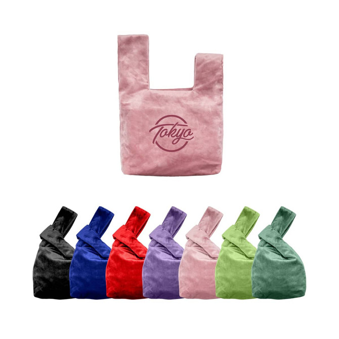 A pink velvet knot wrist bag with a logo, accompanied by bags in black, blue, red, purple, and green.